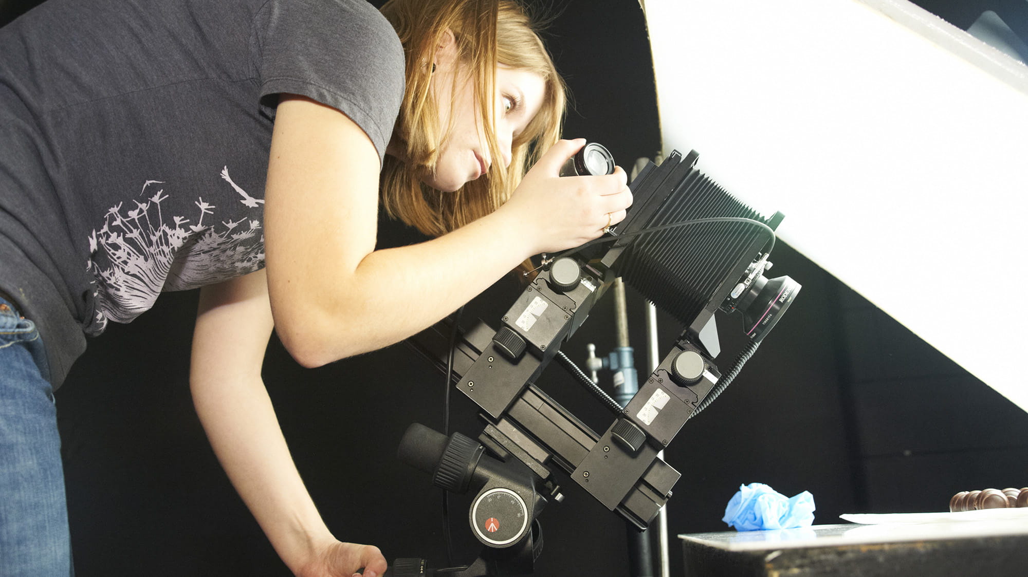 A student working with a large camera in the Photography Lab