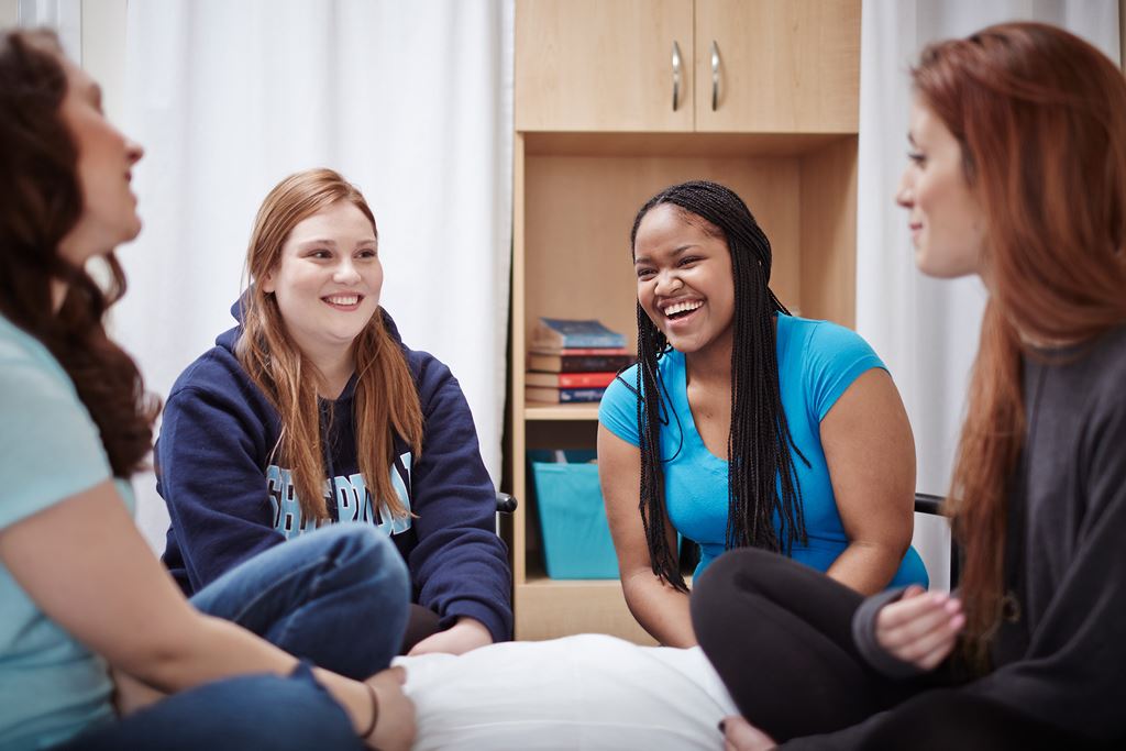 Four students in conversation in a Sheridan Residence room