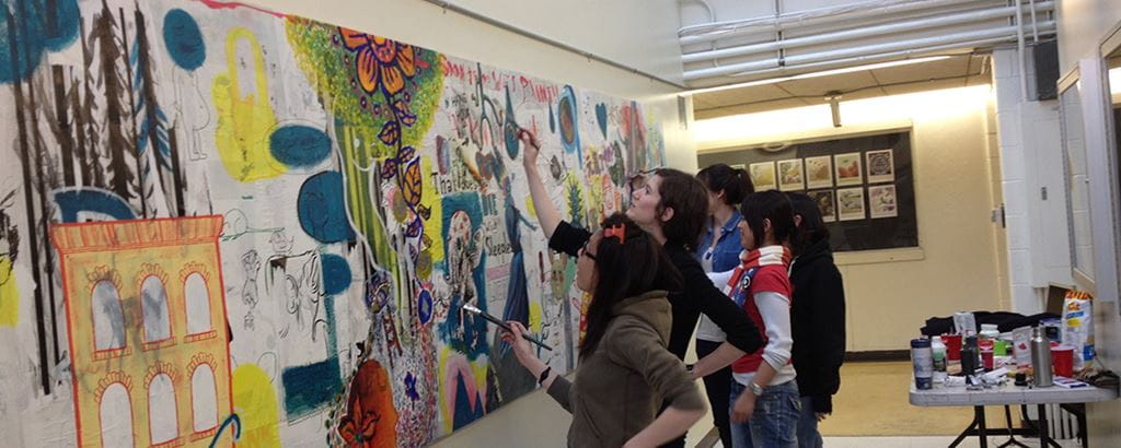 Illustration students work on mural