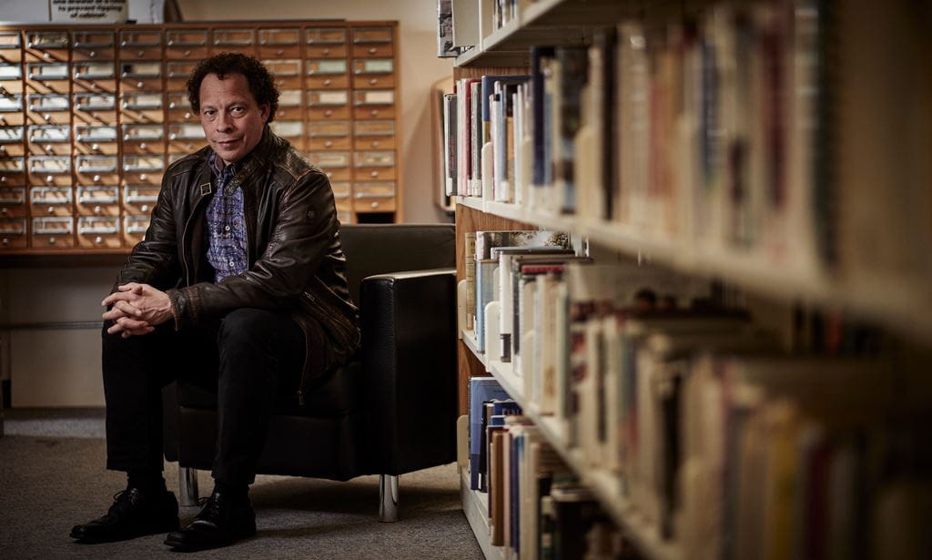 Image of Lawrence Hill sitting upright in comfortable chair.