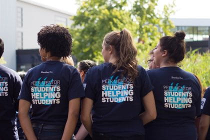 Peer Mentors at a training event wearing 'Students Helping Students' t-shirts