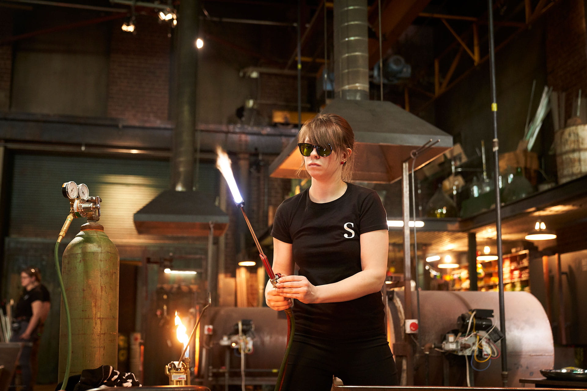 A Sheridan glassblower working with glass on the set of Netflix's Blown Away