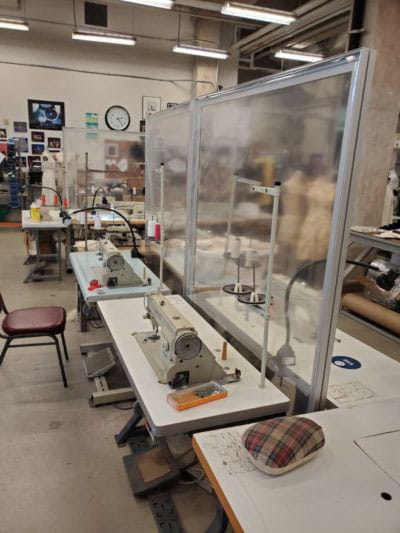 Plexiglass dividers separate workstations to protect students during COVID-19