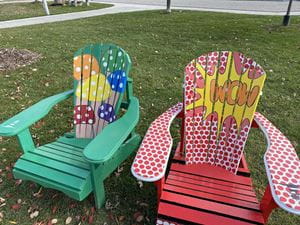Two colourful Muskoka chairs designed and painted by Sheridan students on display in Bronte Heritage Waterfront Park.