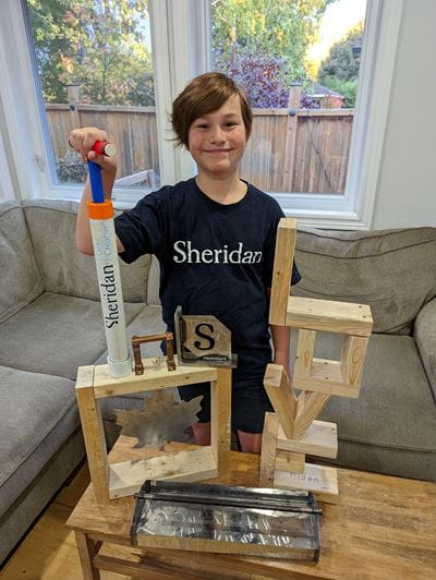 Twelve-year-old Ayden Allen shows the different things he made out of metal and wood during a recent Skills Ontario Summer Camp at Sheridan.