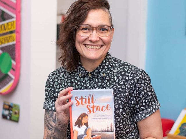 Stacey Chomiak holding a copy of her memoir, 'Still Stace'.
