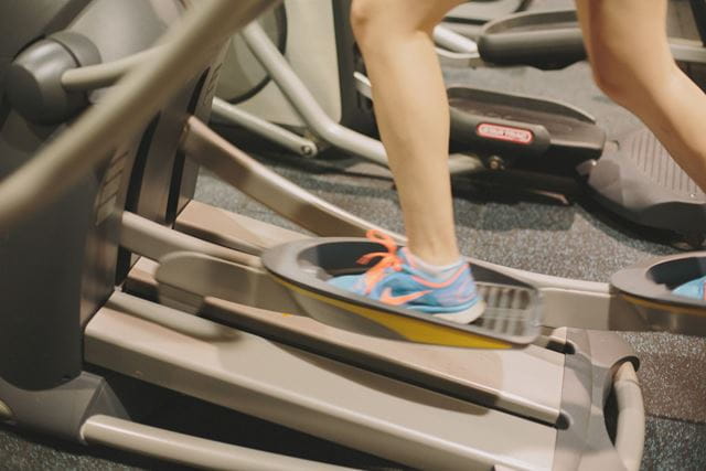 a person jogs on an elliptical