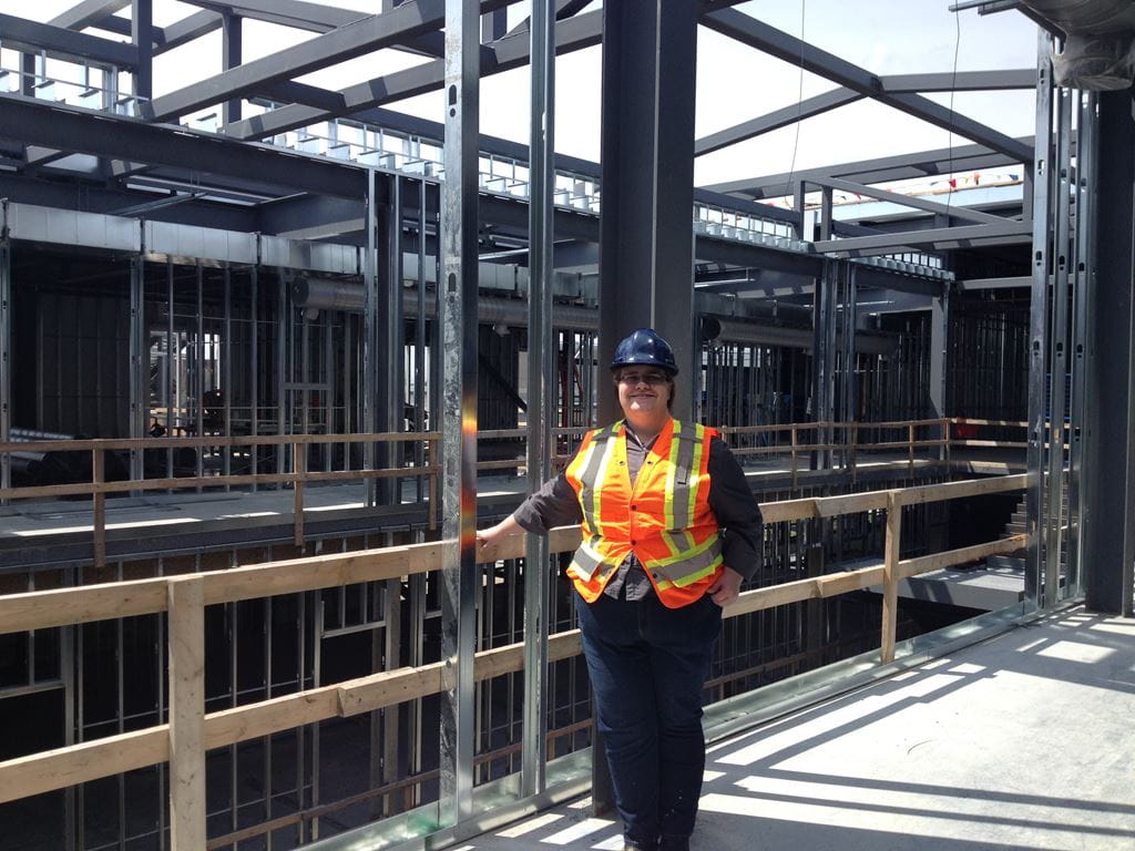 Barbara Smith standing at the Davis Campus A-wing construction site