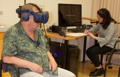 Sheridan student working with an older adult on the Virtual Reality project