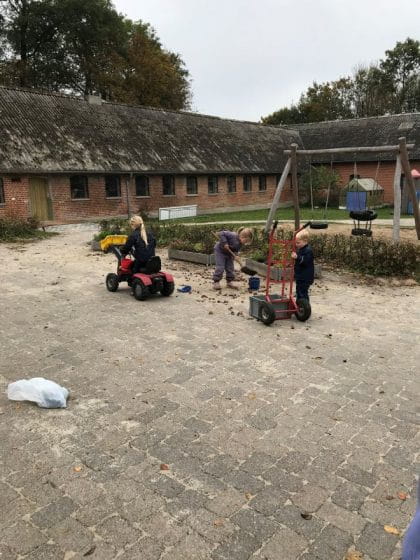 Children digging outside at an early childhood education centre in Denmark.