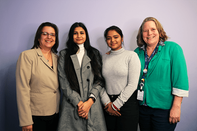 Two Sheridan professors and two students who worked on a research project supporting South Asians living with dementia stand side by side.