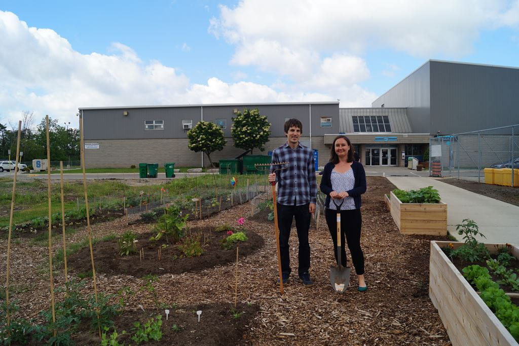 Andrew Staples and Anna Pautler standing in the Sheridan Community Garden