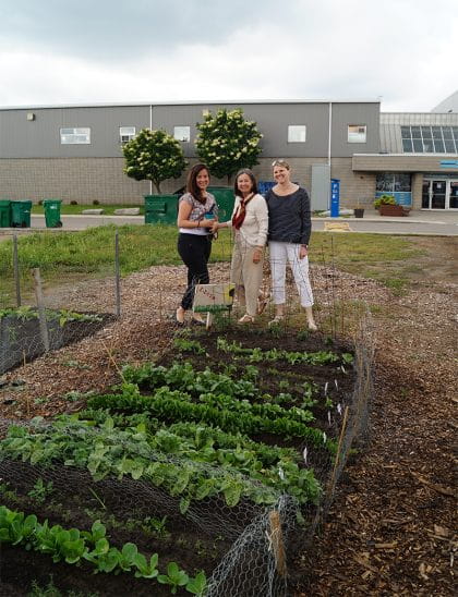 The team from Student Affairs standing next to their plot