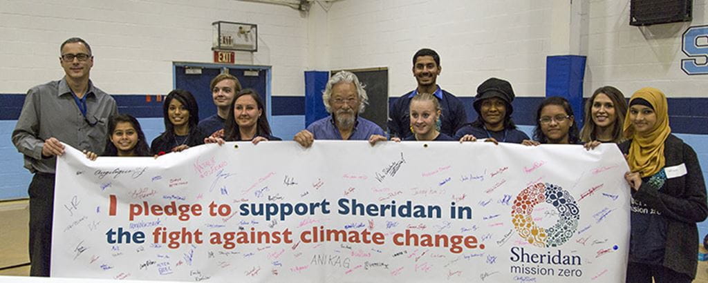Herbert Sinnock, David Suzuki, and students hold a banner in support of Sheridan Mission Zero