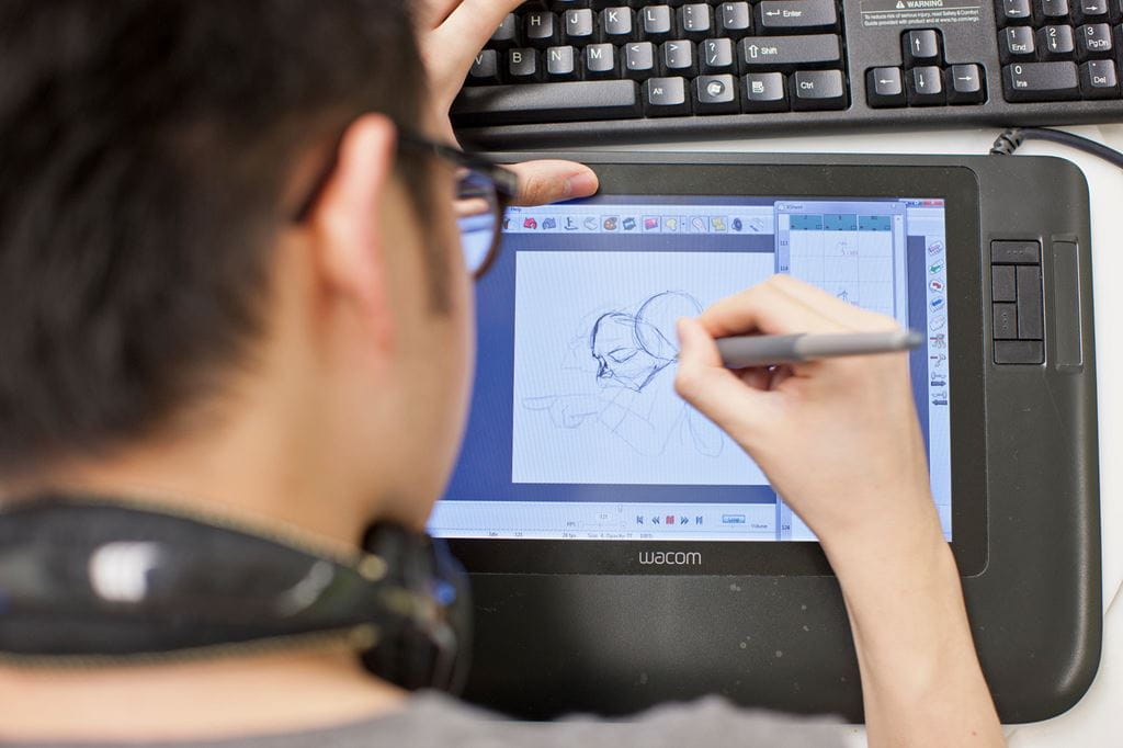 Animation student drawing on a tablet