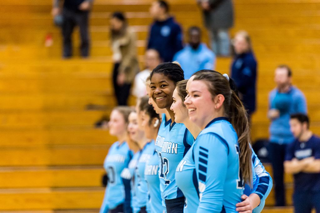 Sheridan Bruins volleyball players smiling on court