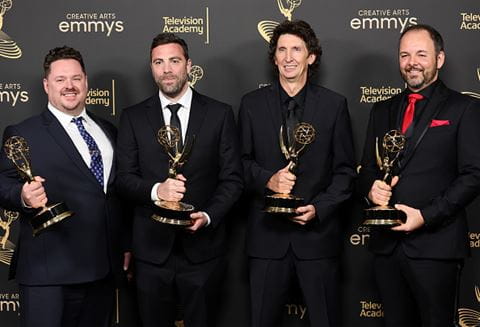 Sheridan alumnus Craig Henighan holding his Emmy Award, pictured second from right