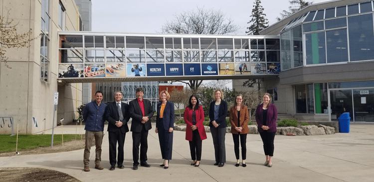 Dignitaries and Sheridan researchers and administrators pose outdoors