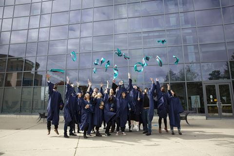 Graduates jumping up to celebrate