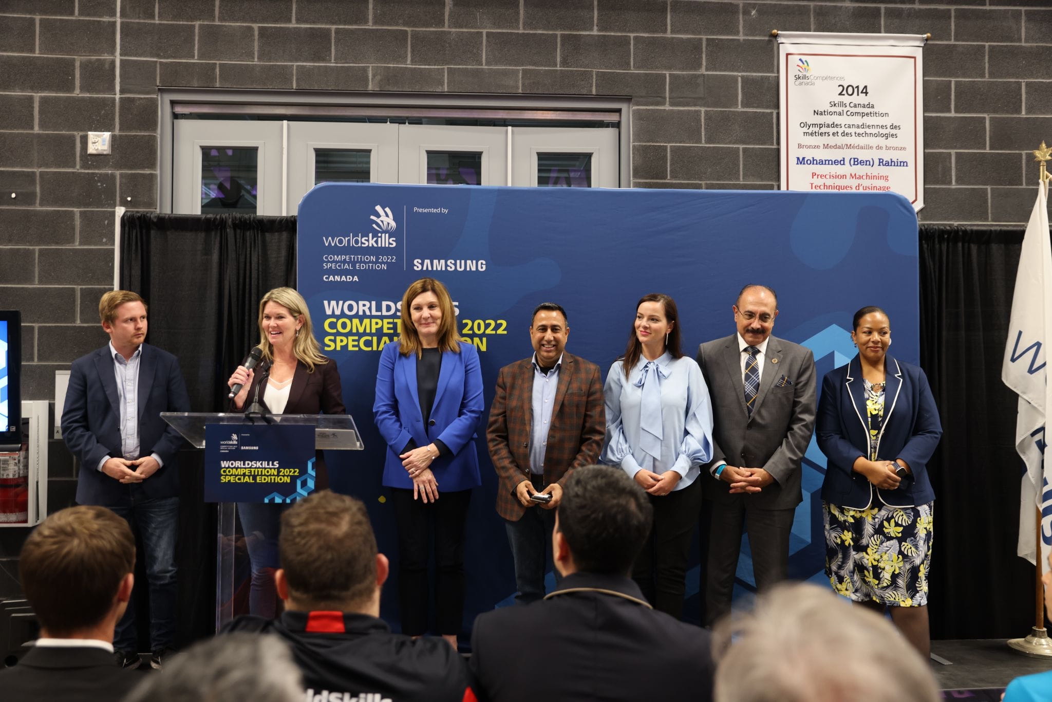 Ontario Minister of Colleges and Universities Jill Dunlop and fellow MPPs Graham McGregor, Natalie Pierre, Deepak Anand, Natalia Kusendova, Sheref Sabawy and Charmaine Williams stand on the stage during the opening ceremonies of the WorldSkills Competition 2022 Special Edition's Industrial Mechanics event.